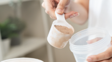 Powder being added to a shaker cup